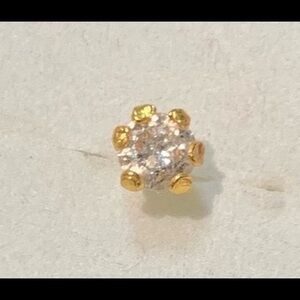 22kt gold with 0.5 carat diamond nose ring, screw type.